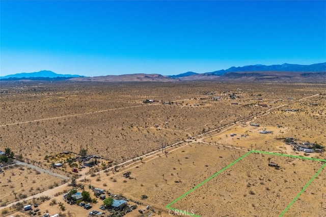 birds eye view of property featuring a mountain view