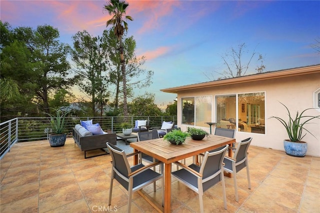 patio terrace at dusk featuring outdoor lounge area