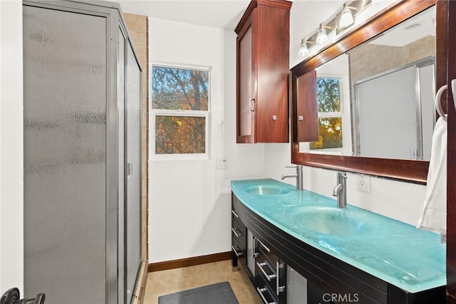 bathroom with vanity, tile patterned floors, and a shower with door