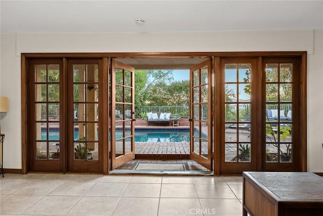 doorway with light tile patterned floors and french doors