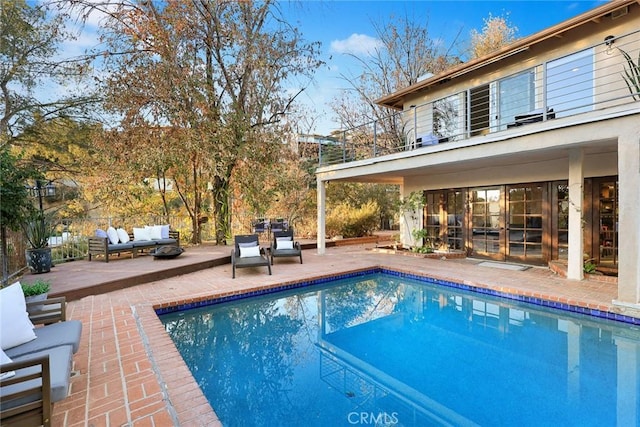 view of swimming pool with outdoor lounge area and a patio