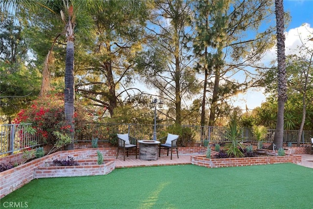 view of yard featuring a fire pit and a patio