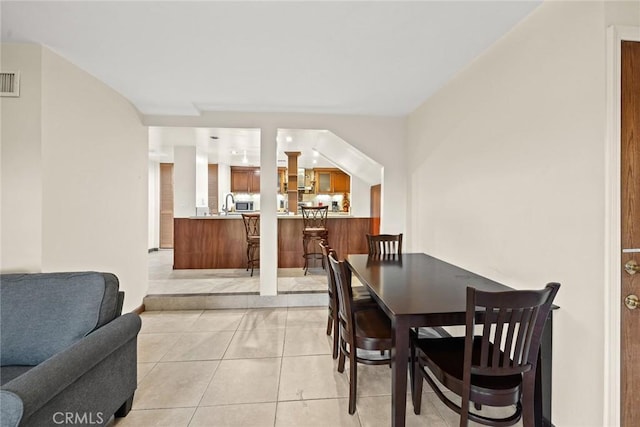 dining area featuring light tile patterned floors and sink