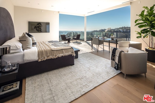 bedroom with hardwood / wood-style flooring and floor to ceiling windows