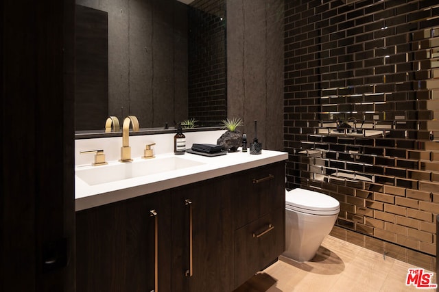 bathroom with tile patterned floors, vanity, and toilet