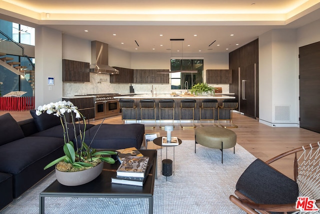 living room with light wood-type flooring and sink