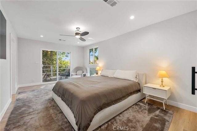 bedroom with hardwood / wood-style flooring, ceiling fan, and access to exterior