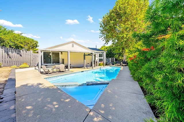 view of pool with an outdoor living space and a patio