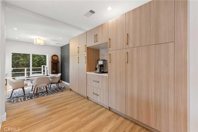 kitchen featuring light hardwood / wood-style floors and light brown cabinetry