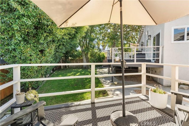 wooden terrace featuring a yard