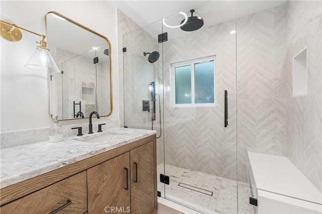 bathroom featuring vanity and an enclosed shower