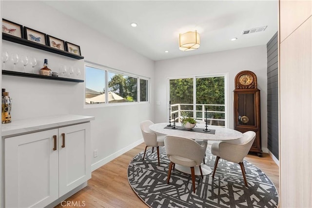 dining space with light hardwood / wood-style floors