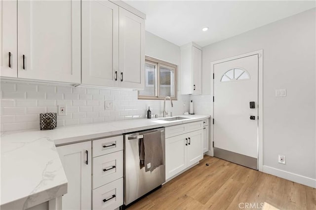 kitchen featuring dishwasher, a healthy amount of sunlight, white cabinetry, and sink