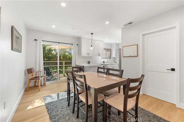 dining room featuring light hardwood / wood-style flooring and sink