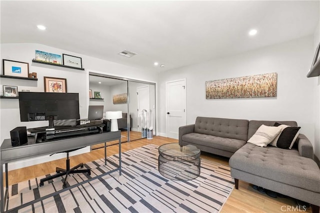 living room featuring hardwood / wood-style floors and lofted ceiling