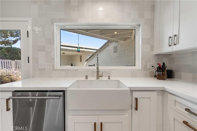 kitchen featuring white cabinetry, dishwasher, a healthy amount of sunlight, and sink