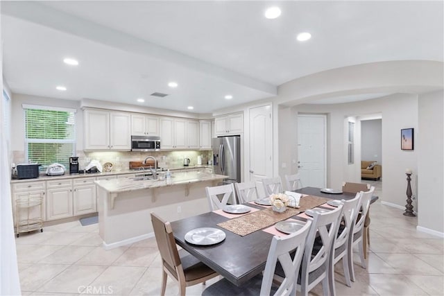 tiled dining area featuring sink