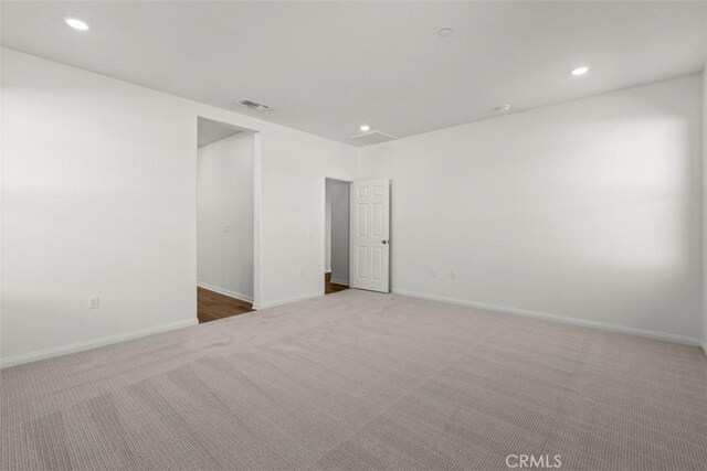 empty room featuring light colored carpet