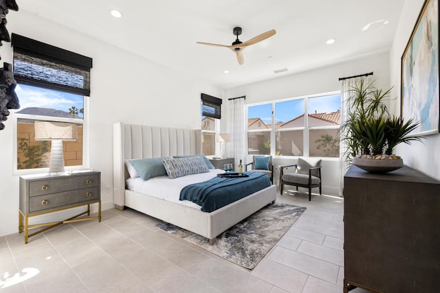 tiled bedroom featuring ceiling fan