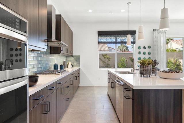 kitchen with pendant lighting, stainless steel appliances, and plenty of natural light