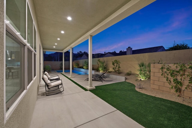 view of patio terrace at dusk