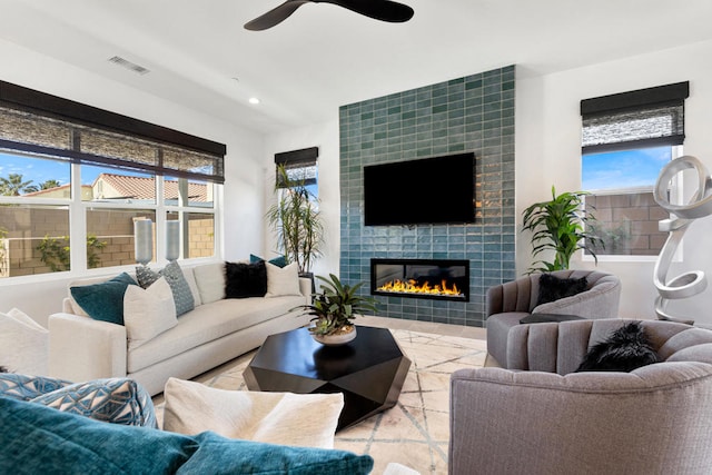 living room featuring a wealth of natural light and a fireplace