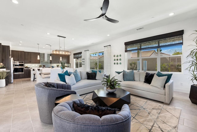 living room featuring ceiling fan and light tile patterned floors