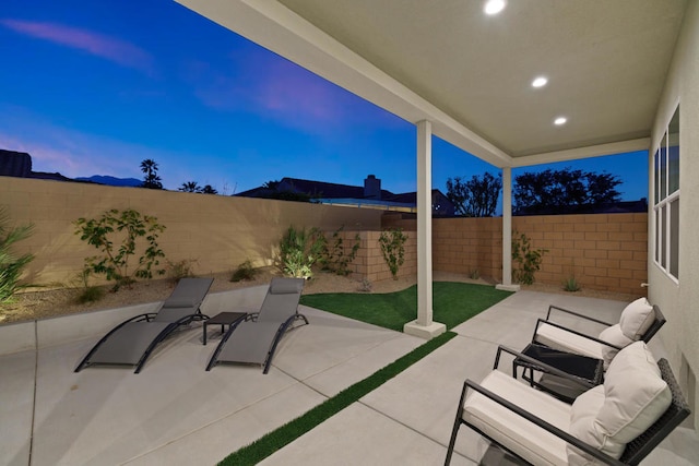 view of patio terrace at dusk