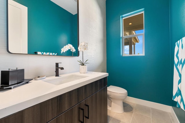 bathroom with vanity, toilet, decorative backsplash, and tile patterned flooring