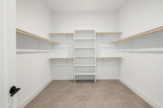 walk in closet featuring light tile patterned flooring