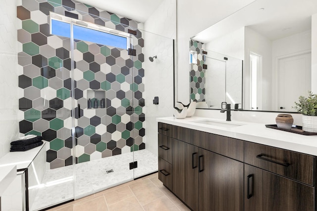 bathroom featuring vanity, walk in shower, and tile patterned flooring