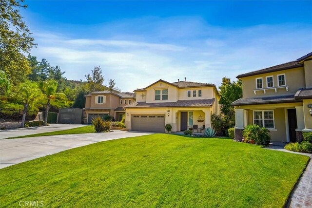 view of front of home with a front yard and a garage