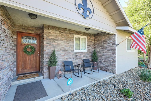 view of exterior entry with covered porch