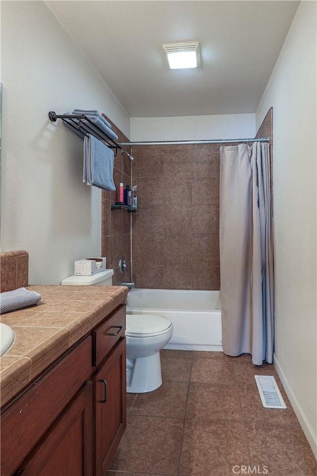 full bathroom with tile patterned floors, vanity, toilet, and shower / bath combo with shower curtain