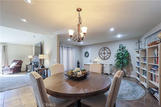 tiled dining area featuring a notable chandelier