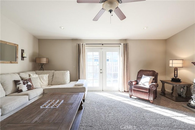 living room with ceiling fan, carpet floors, and french doors