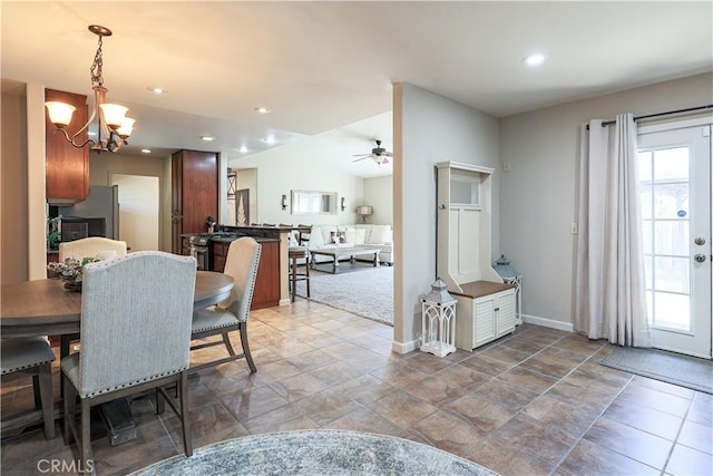 dining room featuring ceiling fan with notable chandelier