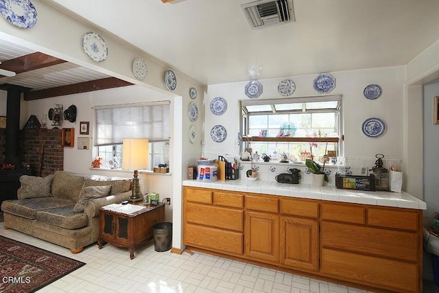 kitchen with a wood stove and tile counters