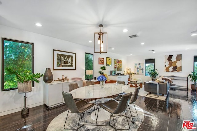 dining space with dark wood-type flooring