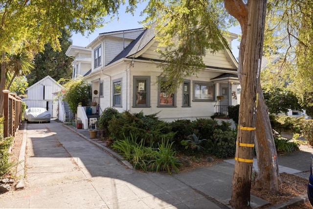 view of front of property featuring a garage and an outdoor structure