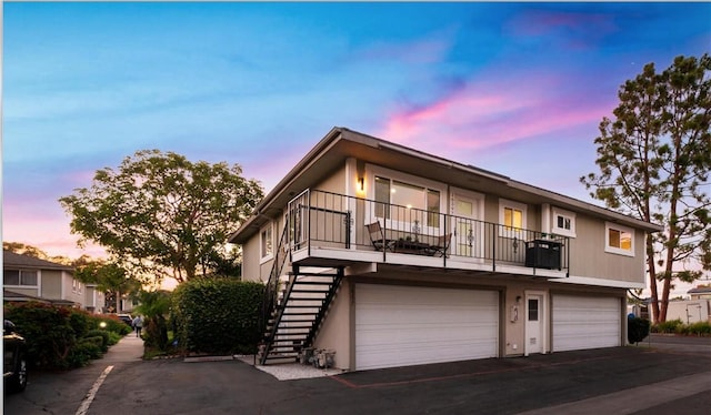 multi unit property with a garage and a balcony