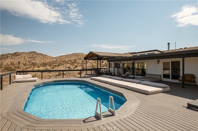 view of pool featuring a deck with mountain view