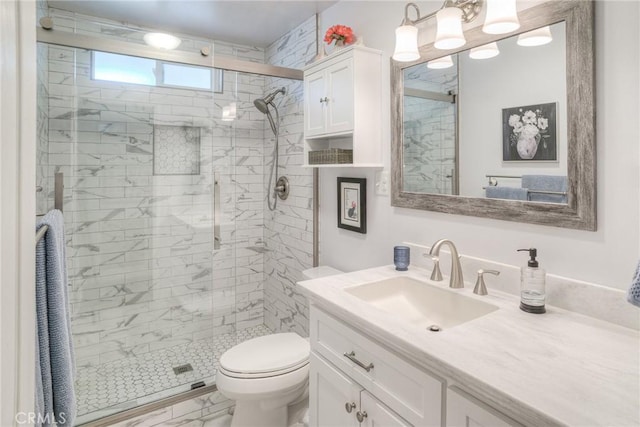 bathroom with vanity, an enclosed shower, and toilet