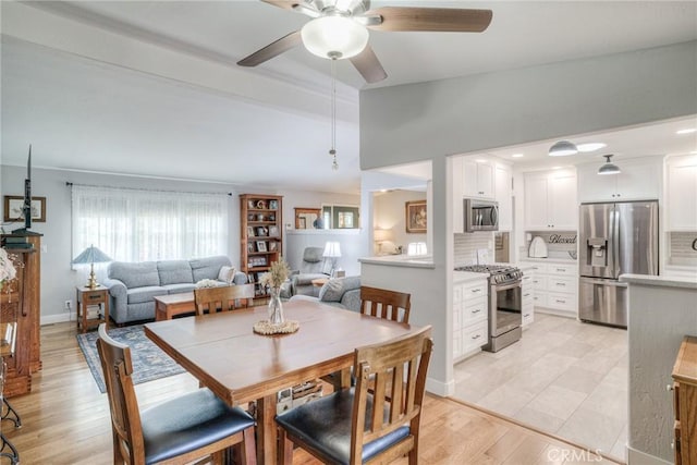 dining area with light hardwood / wood-style flooring and ceiling fan