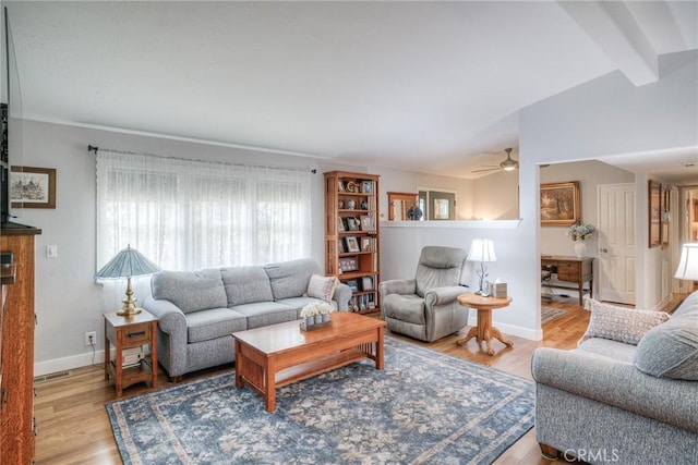 living room with vaulted ceiling with beams, ceiling fan, and light hardwood / wood-style flooring