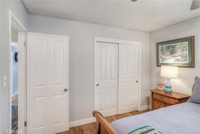 bedroom featuring hardwood / wood-style floors, a closet, and ceiling fan