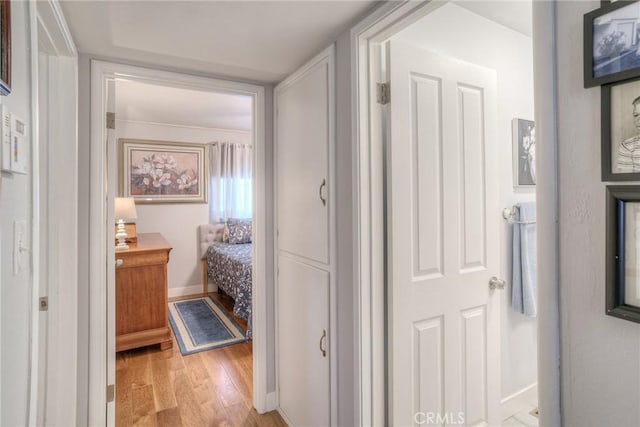 hallway with light hardwood / wood-style flooring