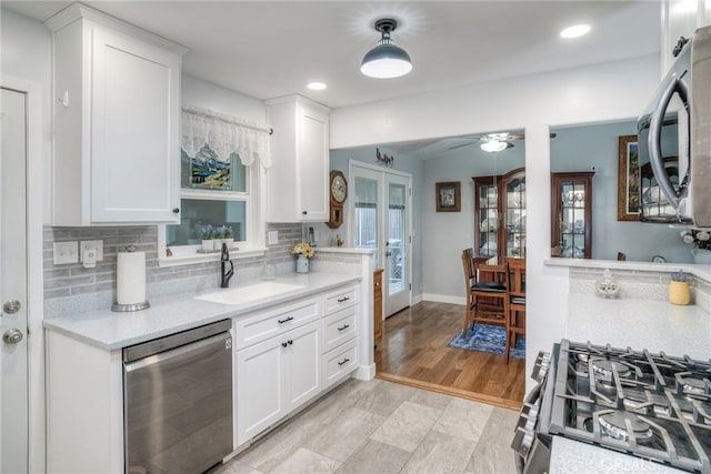 kitchen featuring white cabinetry, stainless steel appliances, sink, and french doors