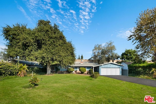 view of front of property with a front yard and a garage