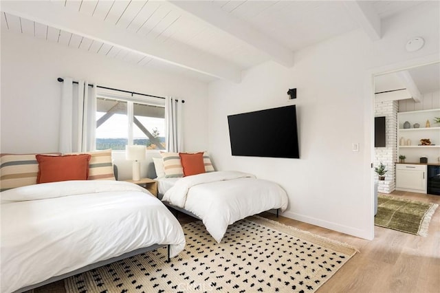 bedroom with beamed ceiling and light hardwood / wood-style flooring